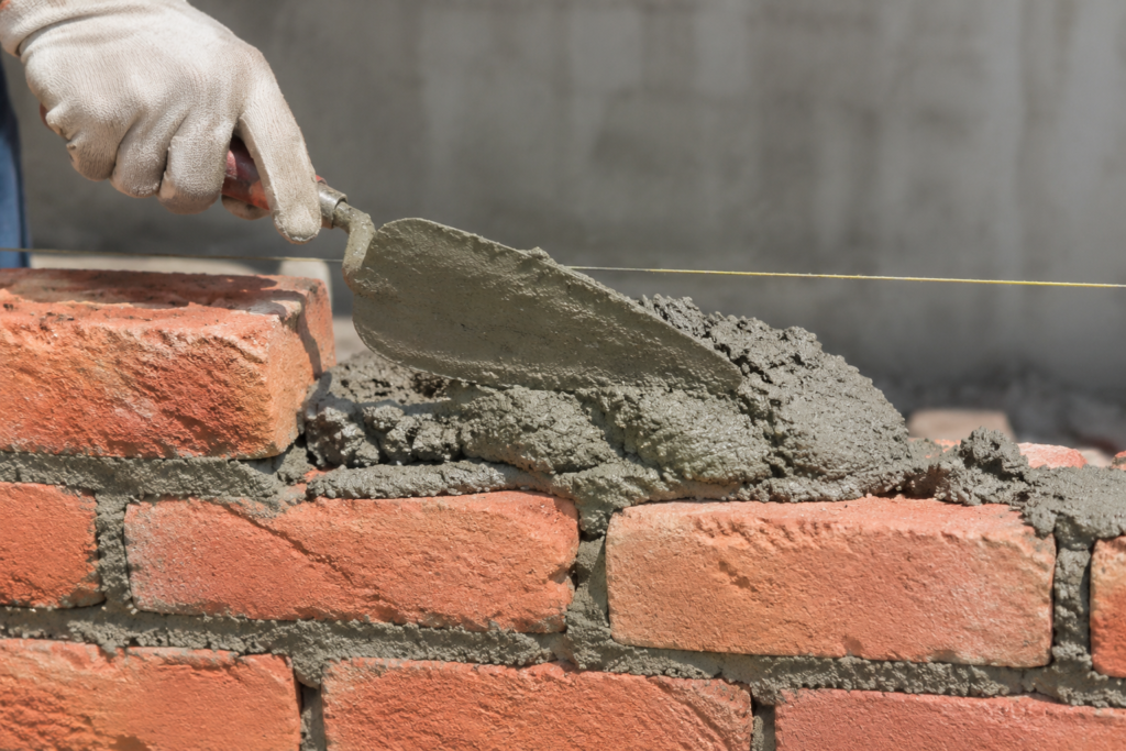 Strongest Mortar Mix Ratio Strong mortar mix being applied to bricks
