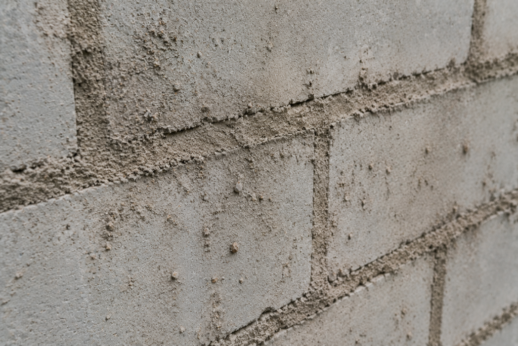 Dirty Substrate Causing Mortar Failure Close-up of a dusty surface before mortar application