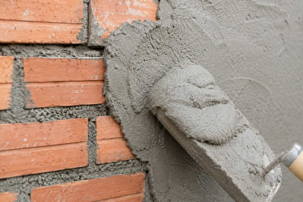 Mortar Thickness Application A close-up shot of thick mortar being applied to a brick wall.