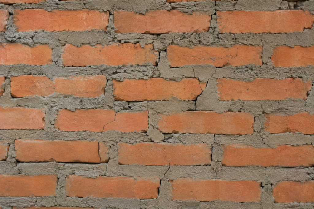 Thick Mortar Joints Problem A brick wall with excessively thick and cracked mortar joints.